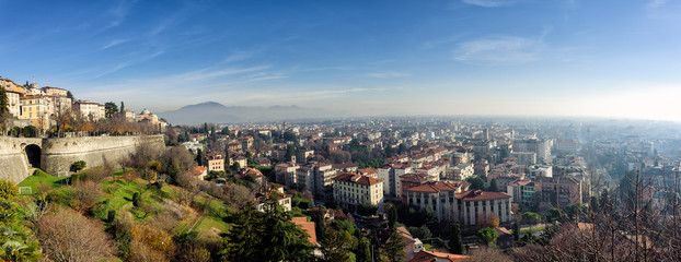 Obraz na płótnie Canvas Aerial panoramic view of foggy Bergamo town in northern Italy