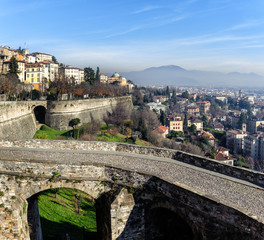Fototapeta na wymiar Ruins of old bridge at old town Cita Alta of Bergamo town in Italy