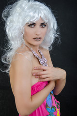 a girl is in a white wig