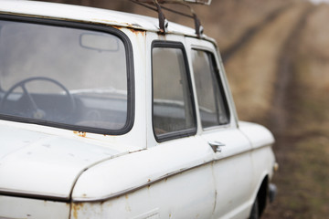 Old car white on a nature background