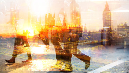 Feet of pedestrians walking against of London view and Big Ben at sunset. Multiple exposure image....