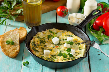 Breakfast background. Scrambled mish-mash with paprika, tomatoes and feta cheese. The concept of healthy nutrition and diet.