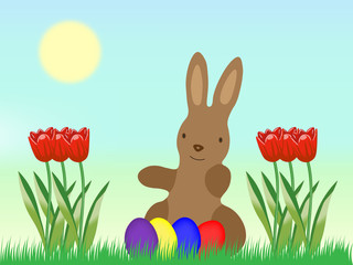 Osterhase mit Eiern und Tulpen auf einer Wiese