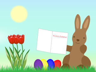 Osterhase mit Grußkarte und Ostereiern auf einer Wiese