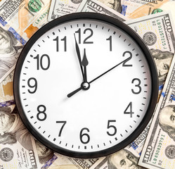 Clock on the background of dollars. Business concept.