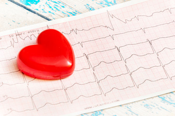 Red Heart with cardiogram on the table. Medical concept.