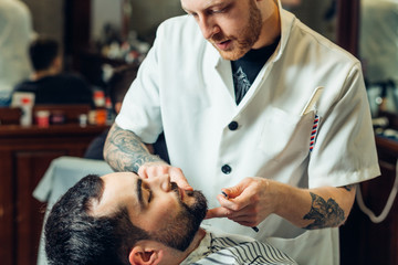 Man having a shave at the barber shop.
