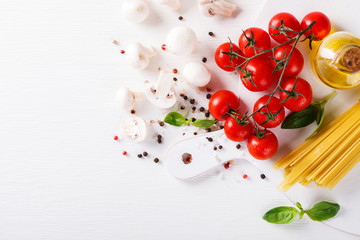 Pasta Spaghetti with ingredients for cooking pasta on a white background, top view. Copy space for Text. selective focus.