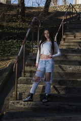 Young woman with  white shirt and ripped jeans