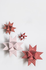 Red and white moravian stars (German christmas ornaments made from paper) on white background
