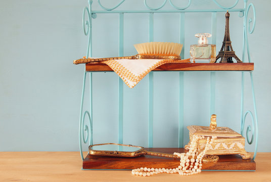 Classic shelf with vintage objects on wooden table