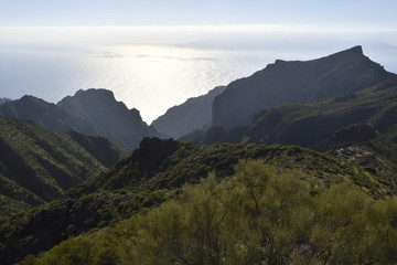 Difficult terrain with mountains and Ravines and the ocean in background