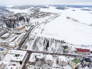 Panorama of Lappeenranta city with snow covered houses, streets and embankment. Finland, Europe. Aerial view at Kaupunginlahti gulf of Saimaa lake