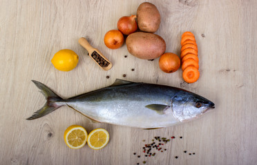 Fish with vegetables, lemon, pepper and herbs. Fresh fish.