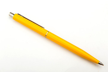 yellow ballpoint pen on a white background