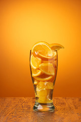 drink bar fresh composition of orange slices in a glass on a deep orange background