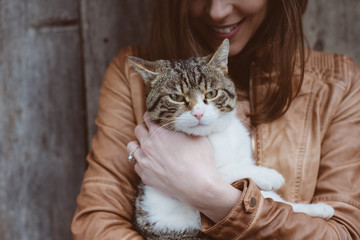 cat lying in woman hands