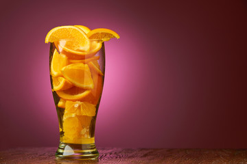drink bar fresh composition of orange slices in a glass on a deep purple background