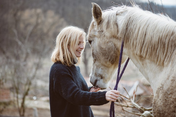 Young beautiful woman with a horse