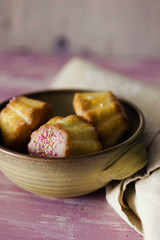 Traditional Polish babka - Easter mini cakes with icing and pink sprinkles. 