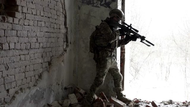Military men with arms defending the building in winter