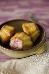 Traditional Polish babka - Easter mini cakes with icing and pink sprinkles. 