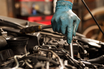 mechanic fixing a car at home