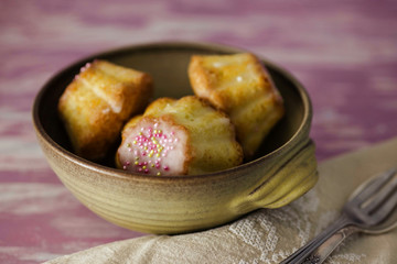 Traditional Polish babka - Easter mini cakes with icing and pink sprinkles. 