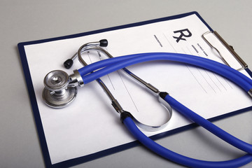 Stethoscope, red heart and medical equipmenton on background