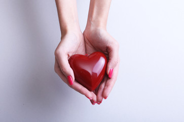 Female doctor hold in hands red heart . Cardio therapeutist, student education, arrhythmia concept