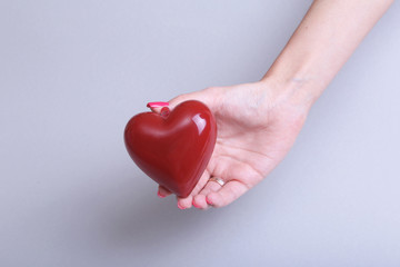 Female doctor hold in hands red heart . Cardio therapeutist, student education, arrhythmia concept