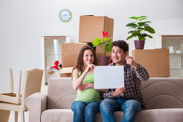 Young couple expecting baby with blank message