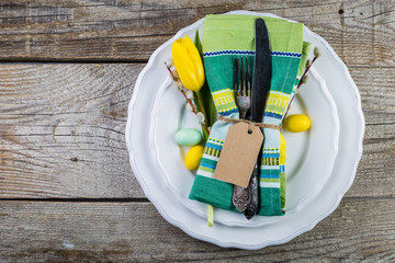 Easter table setting with fluffy willow and tulips
