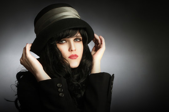 Young romantic woman portrait in black hat