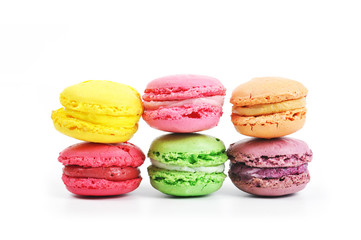 Different types of tasty and colorful macaroons isolated on white background