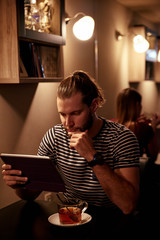 Handsome young man with his tablet