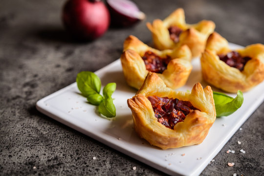 Red onion and sun-dried tomato mini tartlets