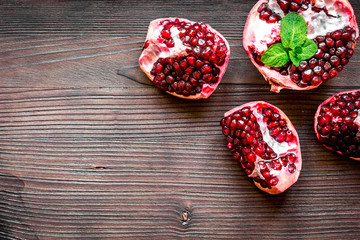 sliced pomegranate on wooden background top view