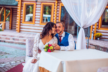 bride and stylish groom on the restaurant terrace