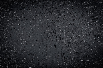 Water drops on dark stone