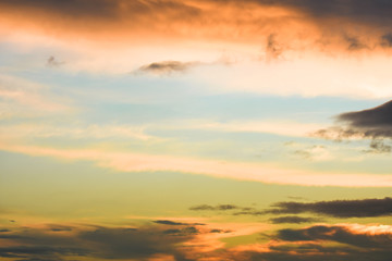 Naklejka na ściany i meble Blue sky between orange clouds. Sunset with clouds.