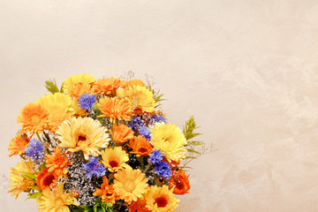 Bouquet of flowers on gold background. Top view, flat lay