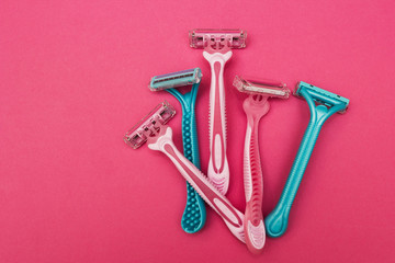 Blue and pink female razor on a pink background