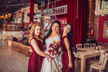 Laughing bride and bridesmaids tell funny stories 