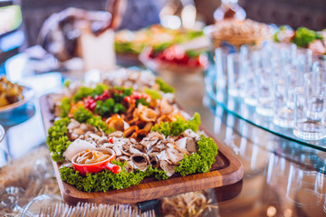 Buffet table of reception with cold snacks, meat and ham