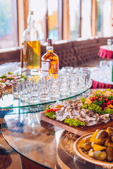 Buffet table of reception with cold snacks, meat and ham