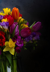 Obraz na płótnie Canvas bouquet of bright spring flowers on black background
