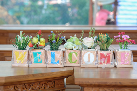 Welcome flower / Decoration flower with word welcome on the table.