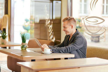 Portrait of a young man in a cafe
