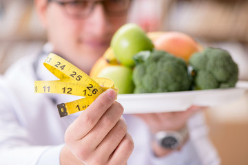 Doctor in dieting concept with fruits and vegetables